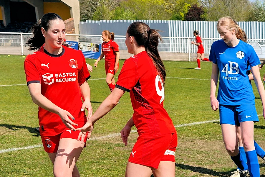 Bria Abbiati (left) congratulates Maddie Biggs (9) for her goal.